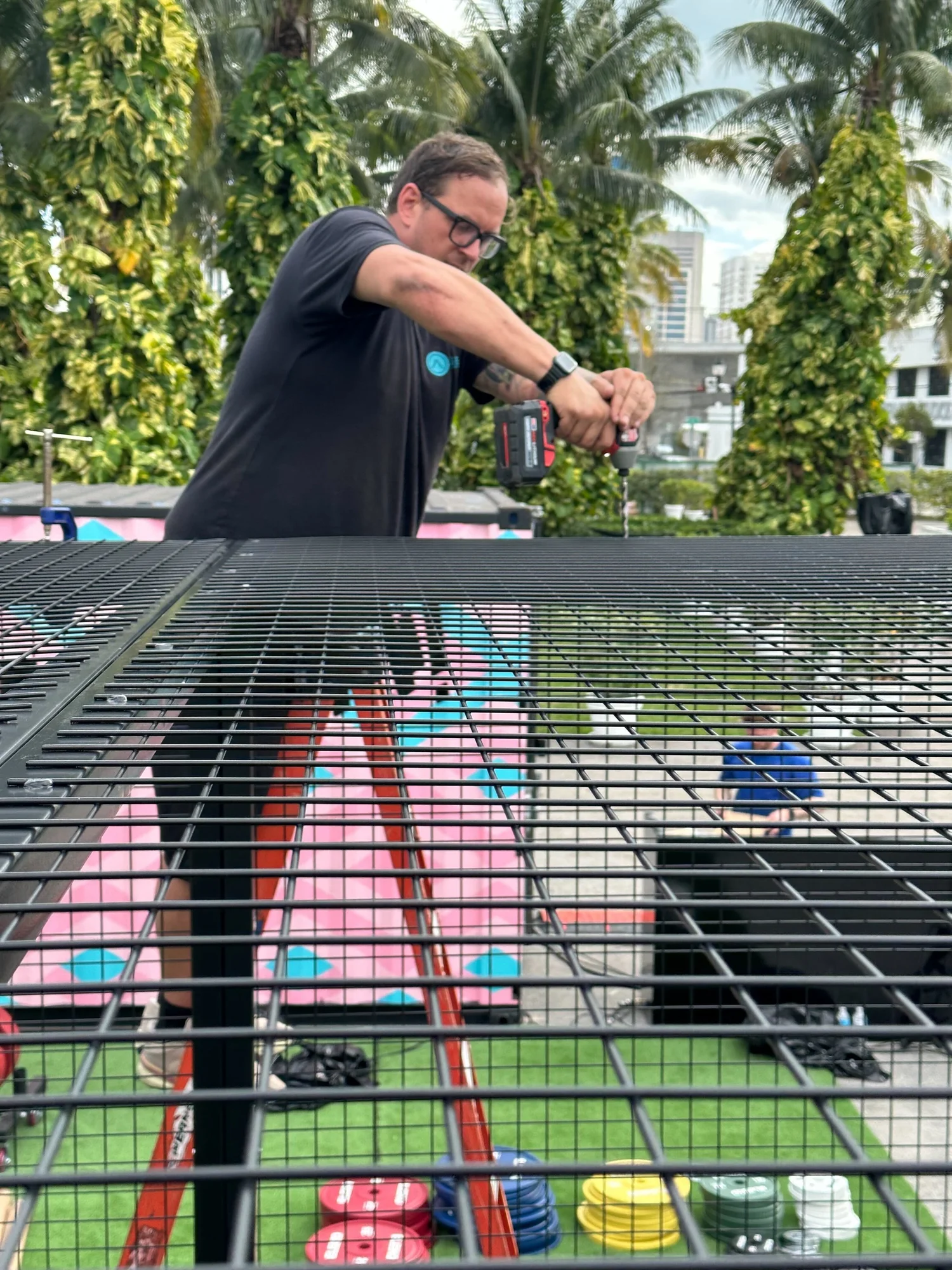 RISE crew member drilling infrastructure at an outdoor event in Miami