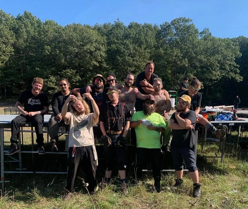 Group of men on metal scaffolding outdoors