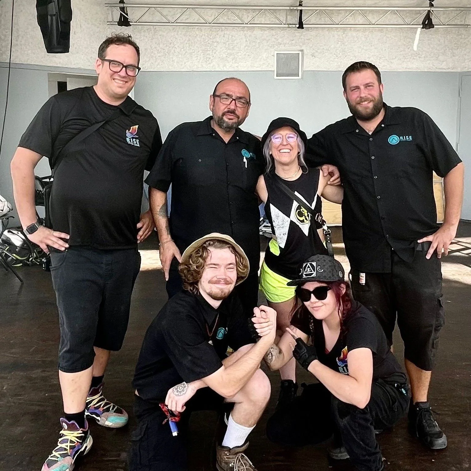 Group of six people posing together indoors