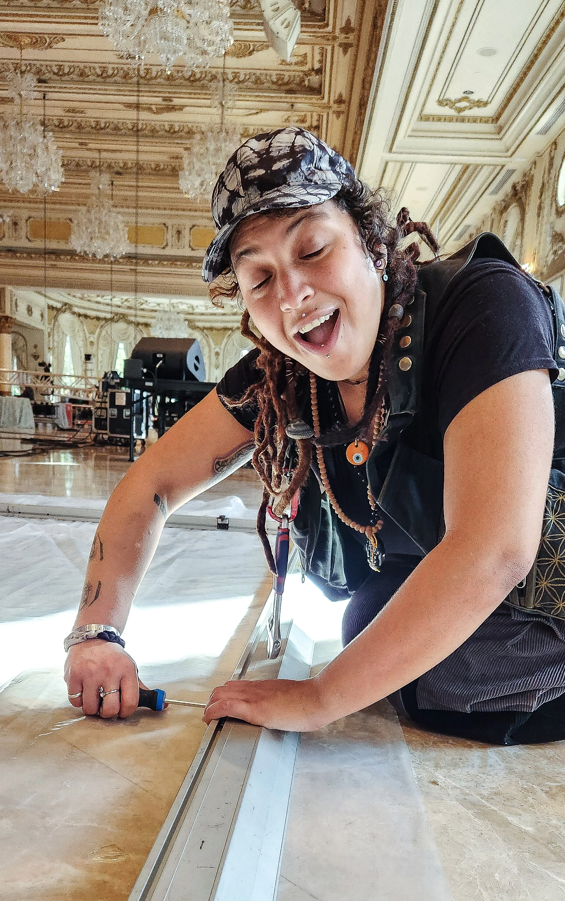 Woman using screwdriver on wooden floor