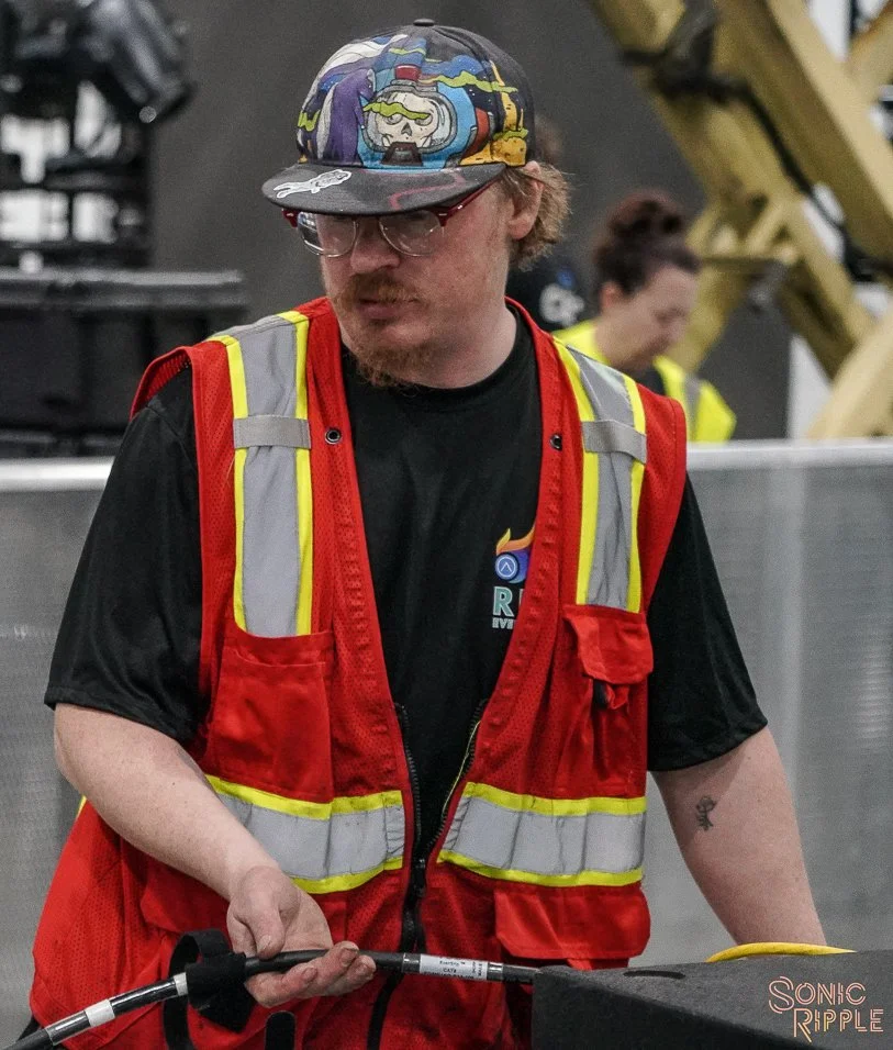 Young man in safety vest working with equipment