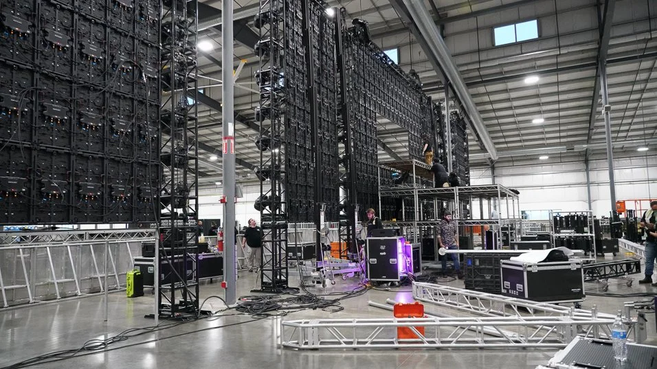 Large warehouse with metal scaffolding and stage setups