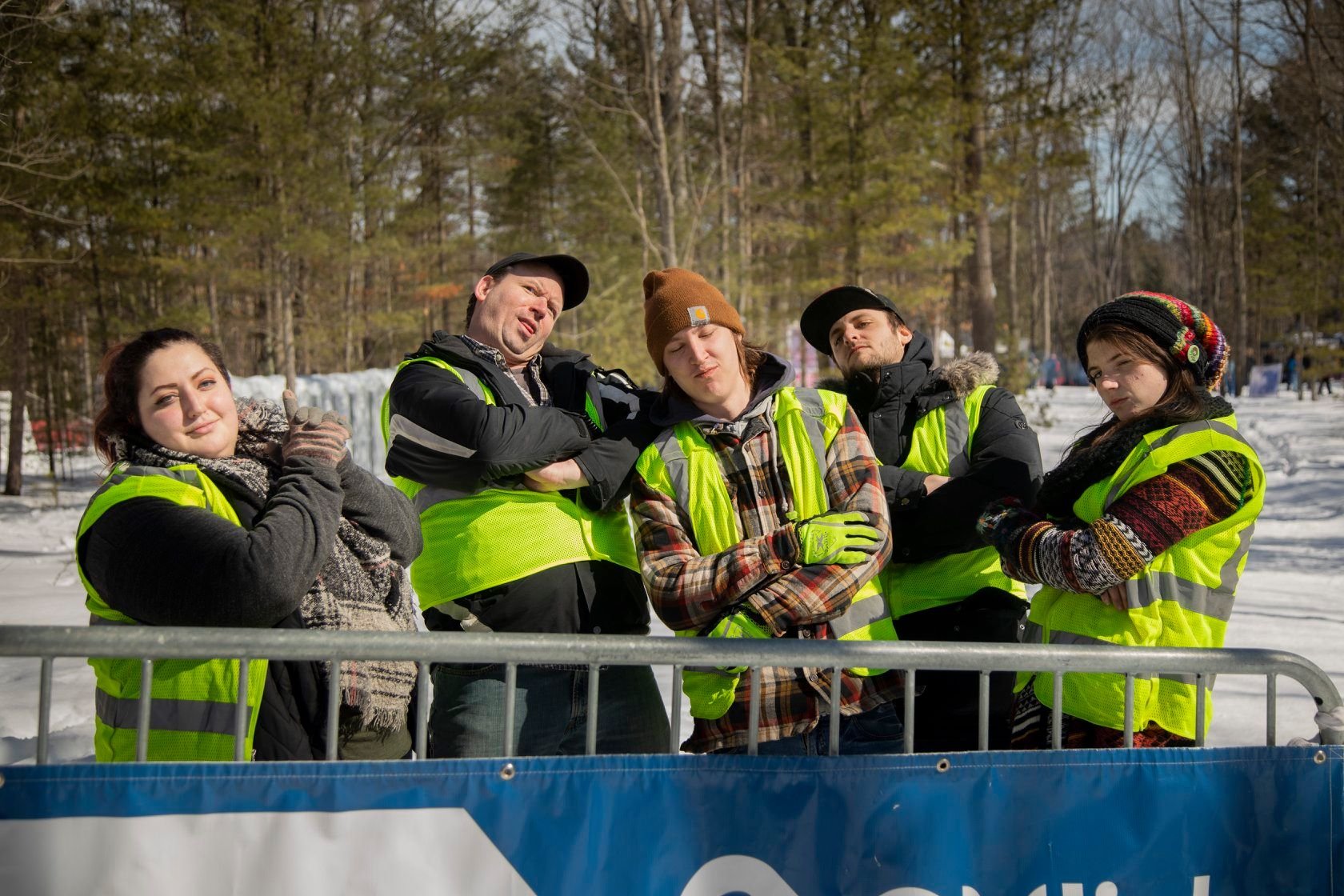 Five people in winter gear and hi-vis vests